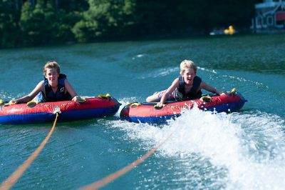 Campers riding tow tubes on the lake at Athens YMCA Camps