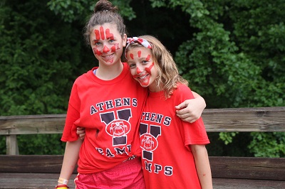 Two smiling Athens YMCA Camps participants shown on the summer camp forms page